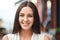 Headshot of pleasant looking charming smiling young woman with healthy skin, dark hair, being in good mood, shows her natural beau