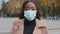 Headshot portrait of African female in facial mask protect from corona virus. Millennial afro woman in facemask against