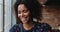 Headshot portrait of beautiful laughing millennial African American woman indoors