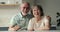 Headshot portrait bonding aged spouses talking to grandkids in videochat