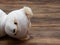 Headshot portrait of cute mummy teddy bear doll bind with white gauze or bandage on dark wooden background
