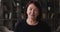 Headshot portrait elderly woman standing indoor looking at camera