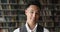 Headshot portrait of handsome Asian guy student pose in library