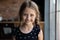 Headshot portrait of happy joyful little girl with funny pigtails