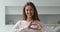 Headshot portrait happy woman showing heart symbol with joined fingers