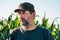 Headshot portrait of male farm worker in cultivated corn crop field