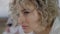 Headshot portrait of sad beautiful Caucasian pierced woman thinking. Close-up face of depressed frustrated slim lady