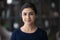 Headshot portrait of smiling Indian woman renter