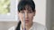 Headshot portrait of young slim woman following pen with eyes. Close-up face of concentrated focused Caucasian female