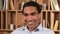 Headshot of positive male employee in formal shirt looking at the camera and smiling