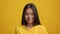 Headshot Of Pretty Asian Young Woman Smiling Over Yellow Background