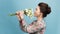 Headshot of pretty young woman with tender smile, healthy skin, carries bouquet of spring flowers, isolated over light blue