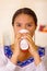 Headshot pretty young woman wearing traditional andean blouse, drinking coffee from white mug