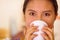 Headshot pretty young woman wearing traditional andean blouse, drinking coffee from white mug