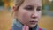 Headshot of sad frustrated cute teen schoolgirl touching cheek and looking at camera with depressed facial expression