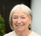 Headshot of a smiling friendly senior woman outdoors