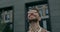 Headshot of stylish guy in glasses looking up and saying wow. Crop view of handsome bearded businessman with neckerchief