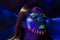 Headshot woman wearing awesome glow in dark facial