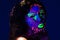 Headshot woman wearing awesome glow in dark facial