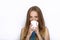 Headshot of young adorable playful blonde woman with cute smile in cobalt color blouse posing with big pure white mug on white bac