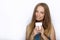 Headshot of young adorable playful blonde woman with cute smile in cobalt color blouse posing with big pure white mug on white bac