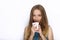 Headshot of young adorable playful blonde woman with cute smile in cobalt color blouse posing with big pure white mug on white bac