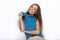 Headshot of young adorable playful blonde woman with cute smile in cobalt color blouse posing on white backdrop