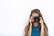 Headshot of young adorable playful blonde woman with cute smile in cobalt color blouse taking photos with black dslr camera on whi