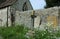 Headstones against a wall.