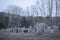 Headstones at an old delapidated looking graveyard on a gray gloomy day in Upstate New York