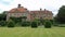 Heale House with lawn and topiary