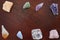 Healing crystals: Rose quartz, amethyst, agate, aventurine, citrine, Calcite and a Clear quartz on a table. Gemstones are used for