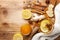 Healing ginger tea in glass mug in scarf with lemon, honey and spices. Autumn hot drink on rustic table top view