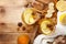 Healing ginger tea in two glass mug in scarf with lemon, honey and spices. Autumn hot drink on rustic wooden table top view