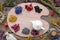 Healing herbs on wooden palette and tea kettle, top view.