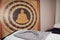 In a healing massage studio on the wall a large East Asian buddha image, in the foreground a massage table, with a white cushion,