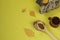 Healing pieces of birch chaga in a wooden spoon on a yellow background. Birch mushroom tea in a ceramic cup. A trendy superfood