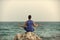 Healt care. Man practicing yoga near blue ocean