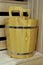 Health and beauty Spa treatments, sauna cabin with sauna accessories. Oak bucket with metal rings for Russian bath and steam room