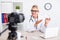 health care and blogging concept - cheerful beautiful woman doctor recording vlog video about medicine