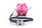 Health care budget and savings piggy bank with stethoscope