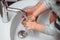 health care concept. Hygiene and disinfection of hands at home. caucasian woman washing little baby boys hands, caucasian