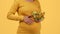 Health care during pregnancy. Unrecognizable pregnant lady holding bowl with fresh salad and stroking belly, free space