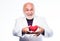 Health care. Preventing heart attack. Senior bald head bearded man holding red toy heart in hands. Healthy life. Mature