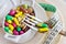 Health care and wellness - diet pills and loosing weight - various tablets in a pot with forks