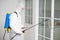 Health care worker in protective face mask using spraying machine to disinfect virus pandemic.  Health care and