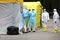 Health care workers wear protective suits as they wait for patients to be tested for coronavirus disease COVID-19 in Riga, Latvi