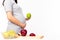 Health concept. Pregnant girl hold green apple or fruit for eating. It is healthy food for mother or pregnant woman. Mom care and