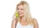 Health conscious woman about to take bite from green apple