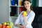 Health. Doctor Dietitian Smiles and Shows Lemon. Woman Holds Fruit in Hands. Young Doctor with a Beautiful Smile at the